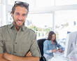 Smiling editor looking at camera with arms crossed