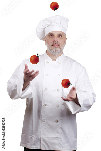 Photo: Cook juggles tomatoes Cook juggles tomatoes