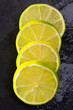 Fresh lima slices with water drops on black