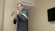Young businessman ties necktie in a hotel room