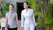 Two happy businesswoman walking in the tourist resort and talkin