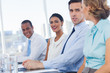 Smiling business people sitting in line