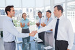 Smiling business people shaking their hands