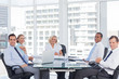 Smiling business people looking at camera during a meeting 