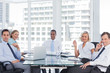 Business people looking at camera during a meeting 