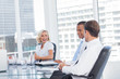 Smiling businesswoman discussing with colleagues