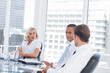 Concentrated businesswoman listening to colleagues