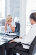 Focused businesswoman listening to colleagues