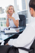 Serious businesswoman listening to colleagues
