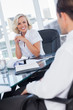 Smiling businesswoman listening to colleagues