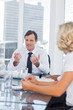 Businessman gesturing while talking to colleagues