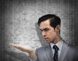 Concentrated businessman holding hand out