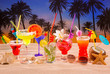 tropical cocktails on white sand mojito on sunset palm trees