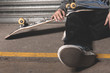Skater sitting on ground with board