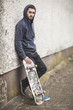 Skater leaning against wall