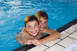 Activities on the pool. Cute boys swimming and playing in water