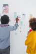 Designers pointing at a group of photos