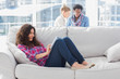 Beautiful worker using tablet pc while laying on a couch
