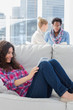 Concentrated worker using tablet pc while laying on a couch