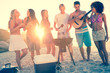 Friends cooking barbecue on the beach