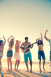 Man playing guitar on the beach 