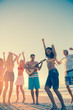 Friends dancing and having fun on the beach