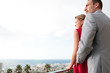 Lovely couple standing on their balcony