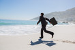 Businessman running on the beach