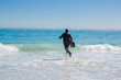 Businessman running into the ocean