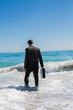 Businessman walking into the sea