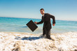 Attractive businessman gesturing in the sea