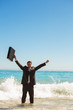 Businessman in the sea raising his arms