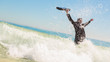 Businessman raising his briefcase in the sea