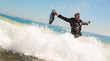 businessman raising his briefcase in the sea