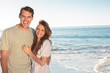 Pretty couple standing and embracing on the beach