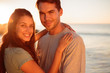 Young lovers embracing on the beach