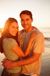 Cute lovers embracing on the beach