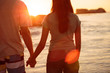 Couple hand in hand on the beach