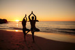 Silhouettes of people doing yoga