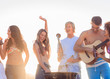 Group of friends having fun together on the beach