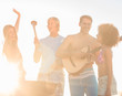 Attractive man playing guitar on the beach