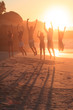 Group of friends jumping during sunset