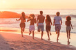 Happy friends running to the sea