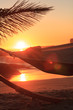People sleeping in hammock on the beach