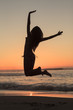 Woman jumping on the beach 