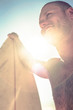 Smiling man holding surfboard