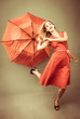 Beautiful woman posing with a broken umbrella