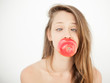 Pretty woman doing a silly face while holding an apple in mouth