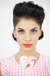 Glamorous young pinup holding a lollipop