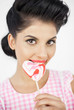 Seductive young pinup biting a lollipop